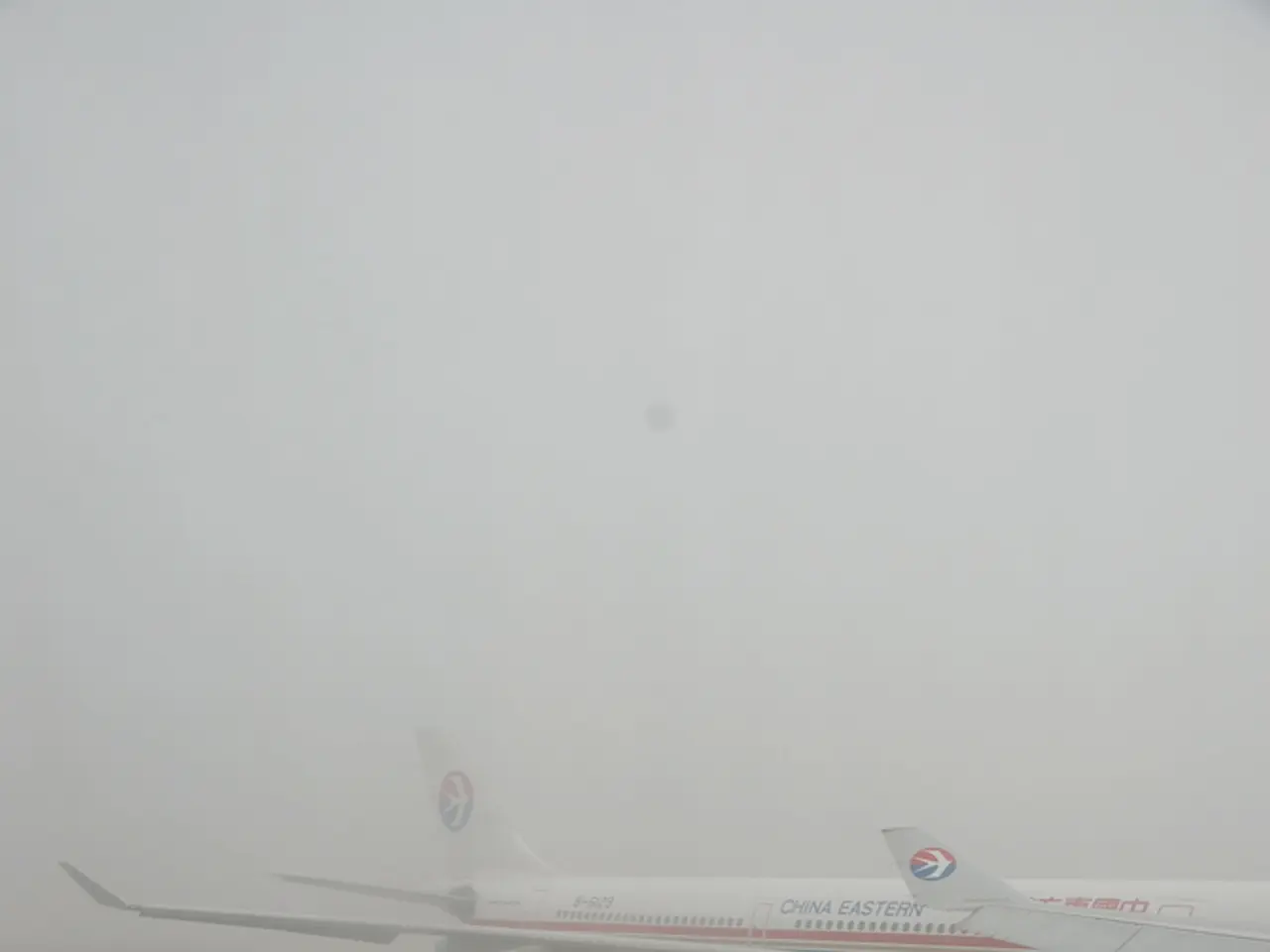 In this image there is an airplane and vehicles on a runway.