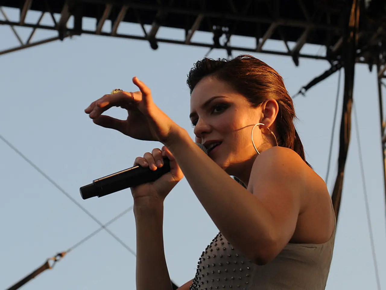 This picture shows a woman performing with the help of a microphone