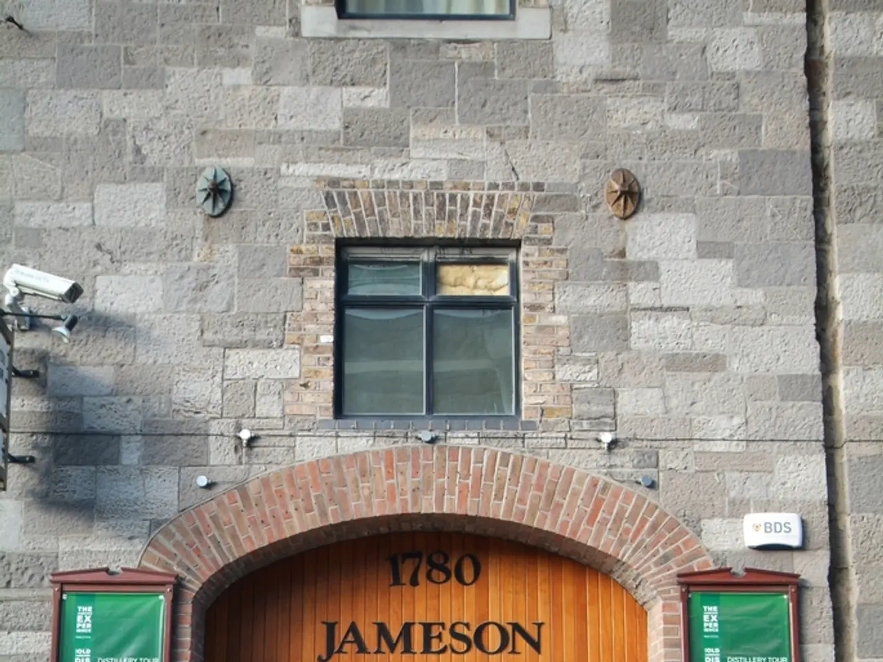 At the bottom there is a road. In the middle of the image I can see a part of a building. There are...