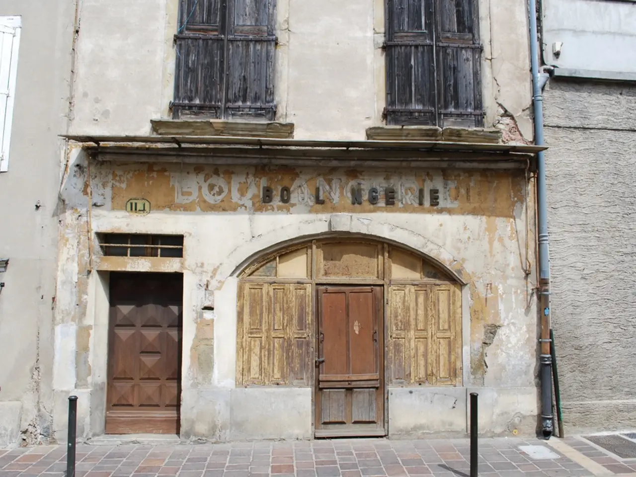 To this building there are windows and doors. Pipe is attached to this wall. In-front of this...