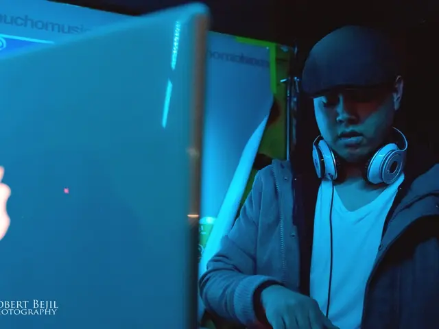 In this image there is one person standing at right side of this image and there is a headphone on...