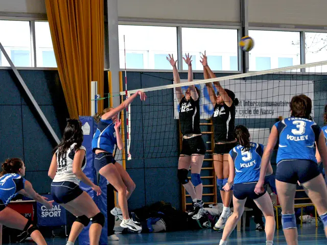 This image is taken indoors. In the background there is a wall and there are a few windows. There...