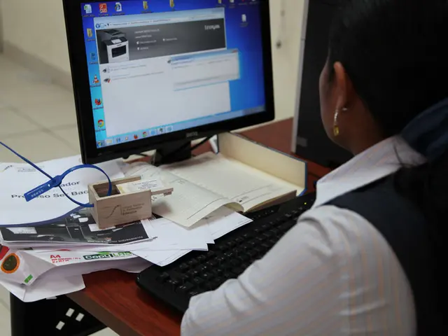 This is the picture inside of the room. There is a person sitting behind the table. There is a...