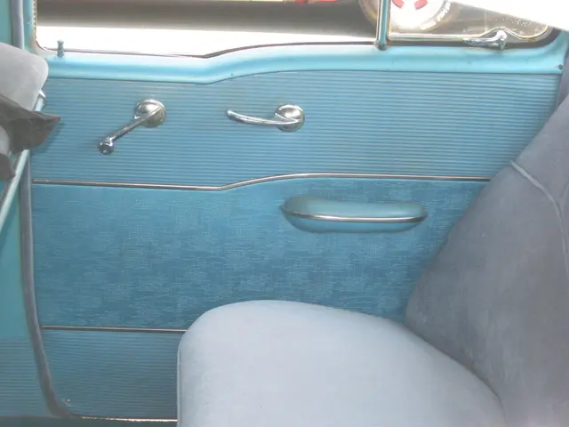 In this image we can see an inside view of a car, there is a seat and handles to the door and there...