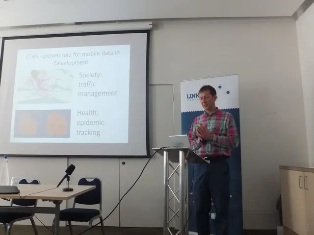 This image is taken in the conference room where a man at the right side is standing in front of...